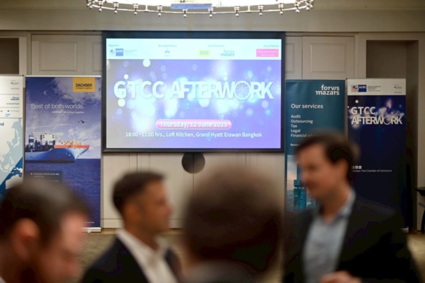 A GTCC AFTERWORK evening, with the event screen and member roll-up banners behind the guests.